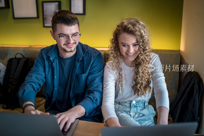 Business people working together at a café using their laptops